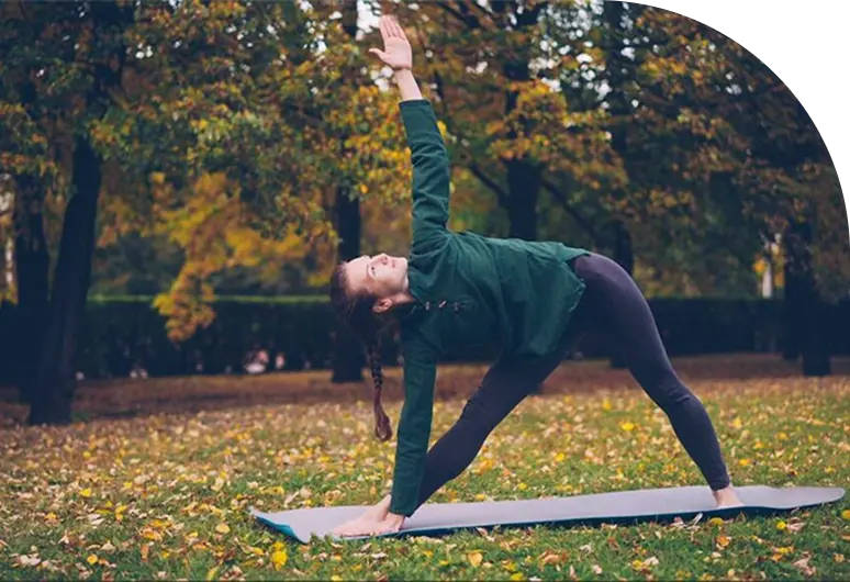 A woman performing yoga in a park